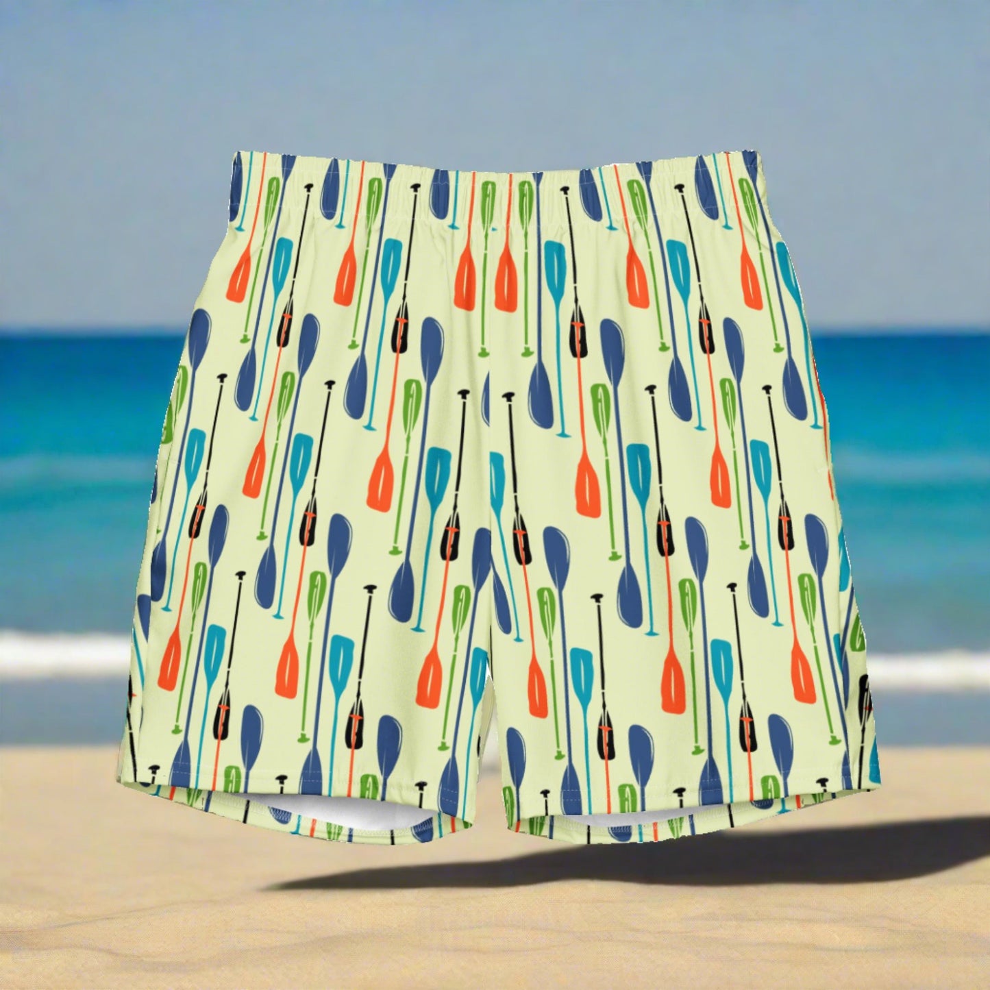 Image of a light green swim trunk with a printed pattern of paddles.