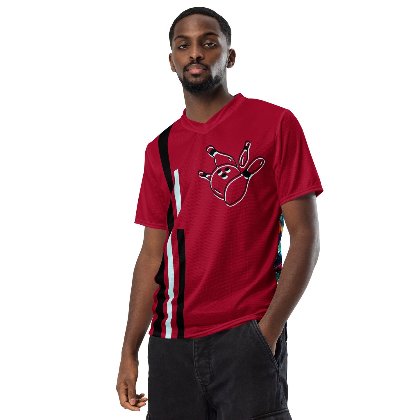 Image of a carmine color sports jersey  with black and white vertical stripes on the left and a an outline design of a bowling ball toppling pins on the top right. The back side has a colorful pattern of bowling balls toppling pins.