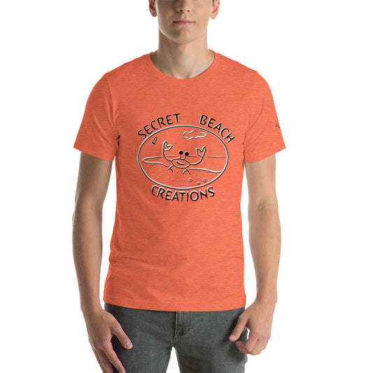 Image of a orange color t-shirt with a ghost crab on a beach with a rocket lifting off in the background black and white outline design with the words "Secret Beach Creations".