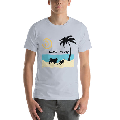 Image of a light blue t-shirt with silhouettes of two playful dogs and a palm tree on a sandy beach and sun with the words "Share the Joy".
